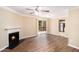 Bright living room featuring a cozy fireplace, modern ceiling fan and wood flooring at 6403 Charter Way, Lithonia, GA 30058