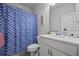 Well-lit bathroom featuring a blue patterned shower curtain and a modern vanity at 2260 Cedar Place Ct, Snellville, GA 30078
