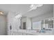 A bathroom with marble countertops, dual sinks, a large mirror, and a bright lighting setup at 2260 Cedar Place Ct, Snellville, GA 30078