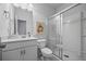 Bright bathroom with a white vanity and a glass-enclosed shower featuring built-in shelving at 2260 Cedar Place Ct, Snellville, GA 30078
