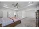 Spacious bedroom with a tray ceiling, natural light, and access to additional rooms, offering comfort and convenience at 2260 Cedar Place Ct, Snellville, GA 30078