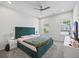 Inviting bedroom with a tufted headboard, a ceiling fan, and ample natural light from multiple windows at 2260 Cedar Place Ct, Snellville, GA 30078