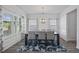 Elegant dining room with large windows, modern chandelier, and seating for six at 2260 Cedar Place Ct, Snellville, GA 30078