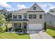 Charming two-story brick home with a well-manicured lawn and inviting front porch at 2260 Cedar Place Ct, Snellville, GA 30078