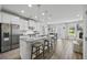 Open-concept kitchen with a large island, stainless steel appliances, and hardwood floors at 2260 Cedar Place Ct, Snellville, GA 30078