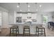 Spacious kitchen with granite countertops, white cabinets, and an island with seating at 2260 Cedar Place Ct, Snellville, GA 30078
