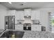 Bright kitchen with stainless steel appliances, white cabinetry, and granite countertops at 2260 Cedar Place Ct, Snellville, GA 30078