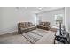 Bright living room with plush carpeting, comfortable seating, and a stylish striped rug at 2260 Cedar Place Ct, Snellville, GA 30078
