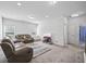 Spacious living room with comfortable seating, plush carpeting, and natural light from large windows at 2260 Cedar Place Ct, Snellville, GA 30078