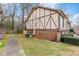 Exterior of building with Tudor-style design, brick foundation, and manicured bushes at 3187 Abbeywood Dr, Decatur, GA 30034