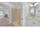 Bathroom featuring a shower with a white vanity with a door to the bedroom at 866 Coopers Ridge Sw Path, Grayson, GA 30017