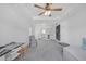 Spacious bedroom with tray ceilings, a ceiling fan, and comfortable seating area at 866 Coopers Ridge Sw Path, Grayson, GA 30017