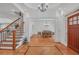 Open foyer featuring stairs, hardwood floors, decorative trim, and a view into the dining room at 866 Coopers Ridge Sw Path, Grayson, GA 30017