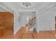 Bright foyer featuring hardwood floors, staircase with white wainscoting, and decorative ceiling trim at 866 Coopers Ridge Sw Path, Grayson, GA 30017