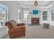 Bedroom seating area featuring a fireplace, oversized windows and comfortable armchair at 866 Coopers Ridge Sw Path, Grayson, GA 30017