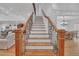 Grand staircase with ornate iron railings and hardwood steps leading to the upper level at 866 Coopers Ridge Sw Path, Grayson, GA 30017