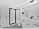 Bathroom featuring black framed shower, white cabinets, light fixtures, and large mirror at 19 Bridgemill Dr, Douglasville, GA 30134