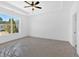 Bedroom with large window, white trim, ceiling fan and door at 19 Bridgemill Dr, Douglasville, GA 30134