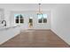Bright dining area with wood floors, modern light fixture, and views to the yard at 19 Bridgemill Dr, Douglasville, GA 30134