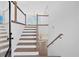 Bright entryway featuring staircase, wood flooring, and modern railing at 19 Bridgemill Dr, Douglasville, GA 30134