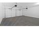 View of an empty, clean garage featuring two garage doors and overhead door mechanisms at 19 Bridgemill Dr, Douglasville, GA 30134