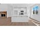 Bright open kitchen with stone fireplace and white cabinets, island, and stainless appliances at 19 Bridgemill Dr, Douglasville, GA 30134