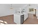 Modern kitchen island with white countertop, black hardware and fixtures, stainless steel dishwasher in open floorplan at 19 Bridgemill Dr, Douglasville, GA 30134