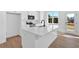 Bright kitchen featuring white cabinetry, stainless steel appliances, and a large center island with a sink at 19 Bridgemill Dr, Douglasville, GA 30134