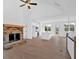 View of modern living area with fireplace, kitchen, hardwood floors and a doorway leading to the outside at 19 Bridgemill Dr, Douglasville, GA 30134