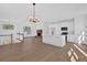 Open-concept living room with vaulted ceilings, fireplace, and modern kitchen at 19 Bridgemill Dr, Douglasville, GA 30134