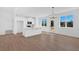 Open-concept living room, dining room and kitchen with hardwood floors and lots of light at 19 Bridgemill Dr, Douglasville, GA 30134
