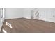 Spacious living room featuring hardwood floors, white walls, and natural light from nearby windows at 19 Bridgemill Dr, Douglasville, GA 30134