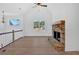Spacious living room with a stone fireplace, vaulted ceilings, large windows and hardwood floors at 19 Bridgemill Dr, Douglasville, GA 30134