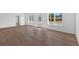 Bright living room featuring white walls, hardwood floors, and natural light from surrounding windows at 19 Bridgemill Dr, Douglasville, GA 30134