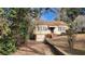 View of the one-story home showing the front entrance and driveway with fall leaves in the yard at 1235 Westboro Sw Dr, Atlanta, GA 30310