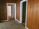 Living room with wood paneling and view of open doorways at 1235 Westboro Sw Dr, Atlanta, GA 30310