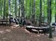 An outdoor playground area nestled in the woods with tire swings, a climbing structure, and tables at 1235 Westboro Sw Dr, Atlanta, GA 30310