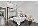 Bedroom featuring a comfortable bed, side tables, and a glass partition wall at 175 Moreland Se Ave, Atlanta, GA 30316