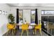 Bright dining area with modern yellow chairs, hardwood table, and views from two large windows at 175 Moreland Se Ave, Atlanta, GA 30316