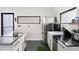Bright kitchen featuring stainless appliances, white cabinetry, black countertops, and modern finishes at 175 Moreland Se Ave, Atlanta, GA 30316
