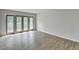 Bright bedroom with modern gray wood flooring and glass patio doors to a railed deck or balcony at 3650 Ashford Dunwoody Rd, Ne, #923, Atlanta, GA 30319
