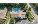 Aerial view of a community pool with lounge chairs, a clubhouse, parking, and landscaped surroundings at 3802 Abbott Ln # 14, Powder Springs, GA 30127
