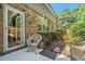 Cozy back patio with wicker chairs, lush greenery, and a well-maintained brick exterior at 3802 Abbott Ln # 14, Powder Springs, GA 30127