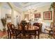 Elegant dining room featuring a chandelier, hardwood floors, and a large wooden table with seating at 3802 Abbott Ln # 14, Powder Springs, GA 30127