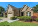 Charming home featuring a well-manicured lawn and garden, and a two-car garage with barn-style doors at 3802 Abbott Ln # 14, Powder Springs, GA 30127
