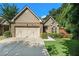 Charming brick home featuring a well-manicured lawn, and a two-car garage with barn-style doors at 3802 Abbott Ln # 14, Powder Springs, GA 30127