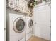 Efficient laundry room with modern washer and dryer units and decorative Easter and spring decor at 3802 Abbott Ln # 14, Powder Springs, GA 30127