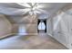Finished attic bedroom featuring neutral paint, a ceiling fan, and natural light at 3871 River Mansion Dr, Peachtree Corners, GA 30096
