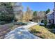 Lush backyard with an in-ground pool, surrounded by trees, driveway and patio with steps at 3871 River Mansion Dr, Peachtree Corners, GA 30096