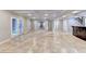 Large open finished basement with tile flooring and access to other rooms at 3871 River Mansion Dr, Peachtree Corners, GA 30096